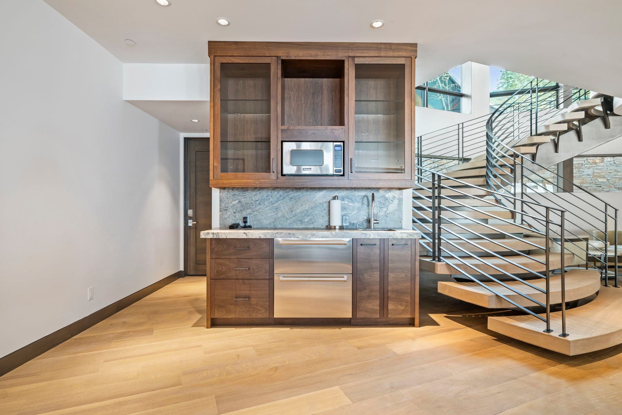 A mini kitchen area with a microwave and sink.