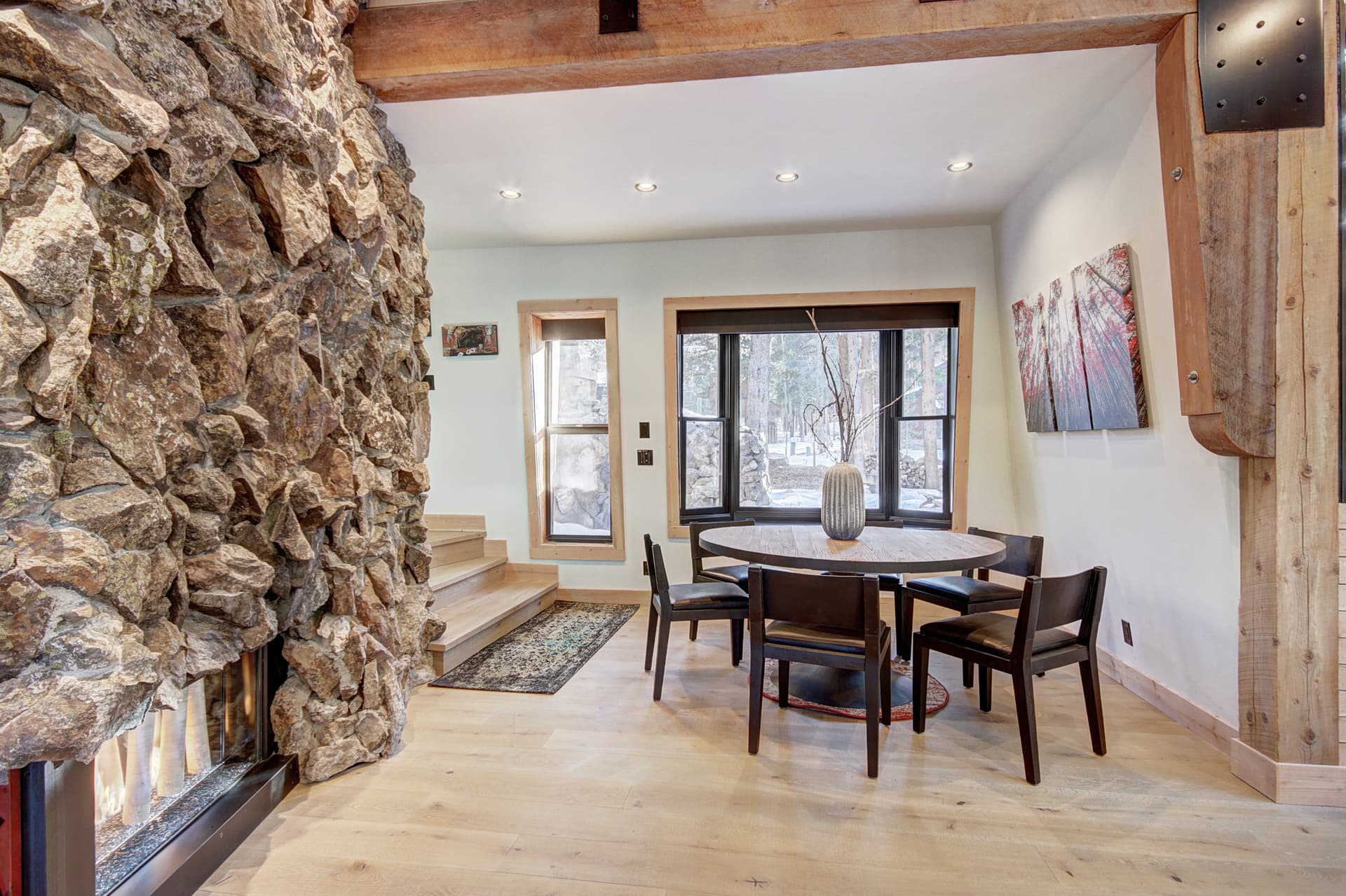 Dining table with seating for 6 situated beside the gas fireplace - Arrow Darrow Breckenridge Vacation Rental
